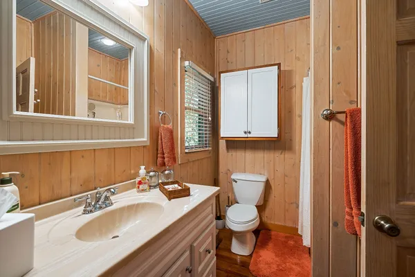 a bedroom with a bed next to a window
