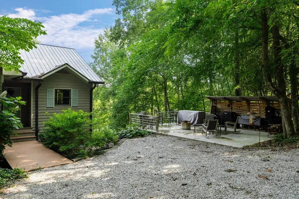 a view of house with backyard outdoor seating and green space