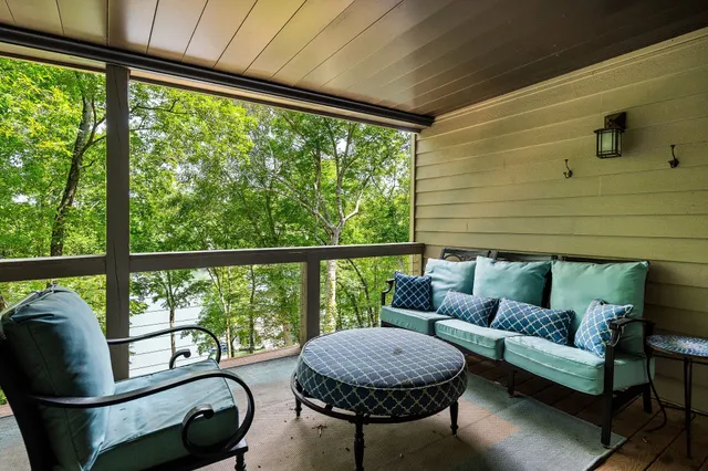 a living room with furniture and a floor to ceiling window