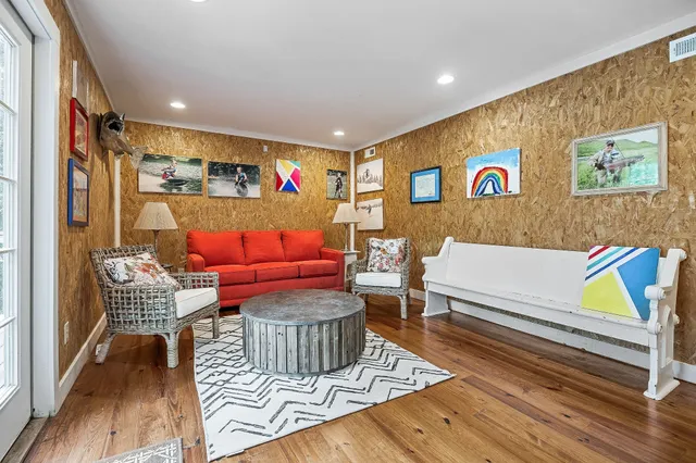 a living room with furniture a fireplace and windows
