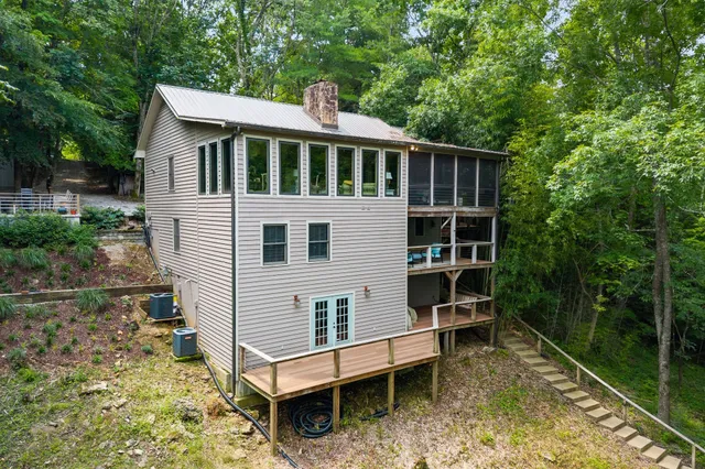 a bathroom with a granite countertop sink a mirror a toilet and a shower