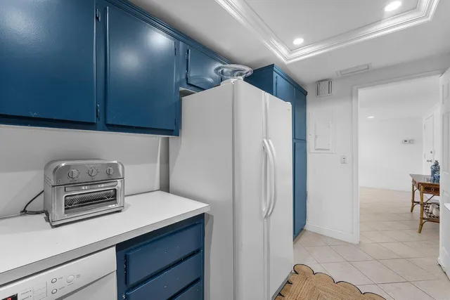 a kitchen with a refrigerator and a stove top oven