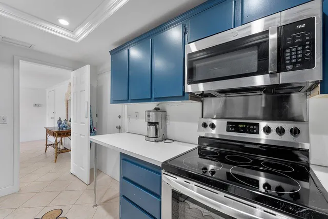 a kitchen with a stove a microwave and wooden cabinets