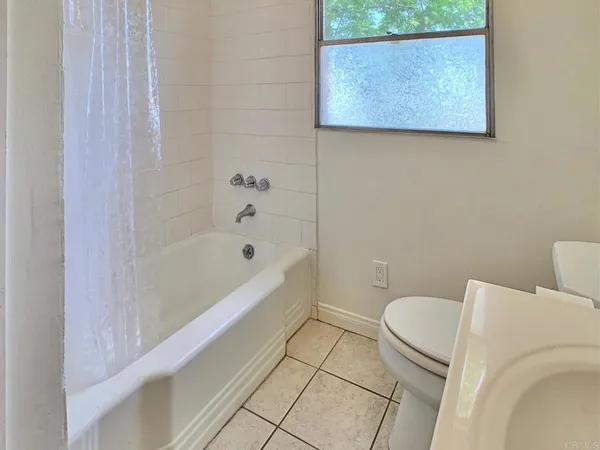 a bathroom with a toilet and a bathtub
