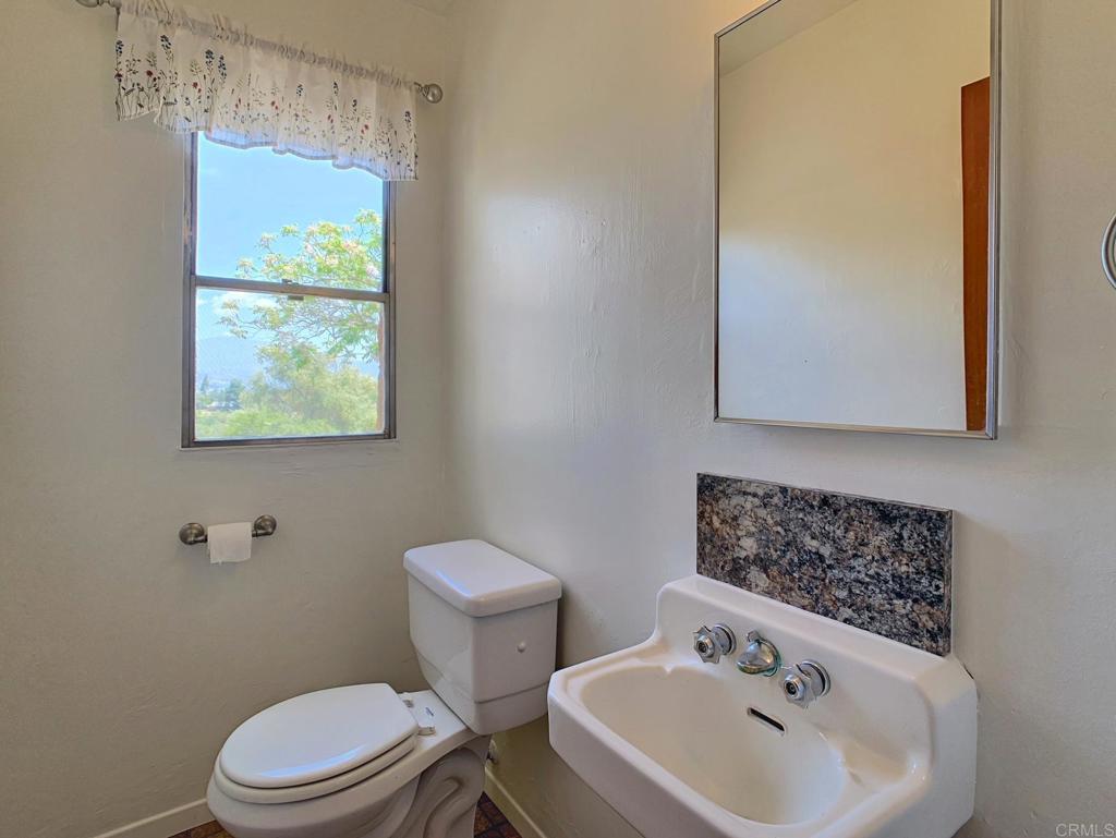 616 Alpine Heights Road Alpine, CA 91901 - Photo 20 of 50 a bathroom with a sink mirror and toilet