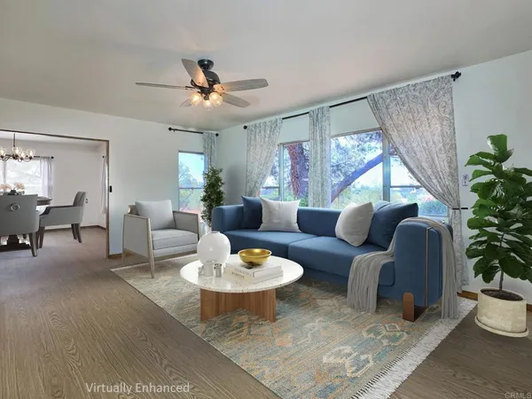a living room with furniture potted plant and a window