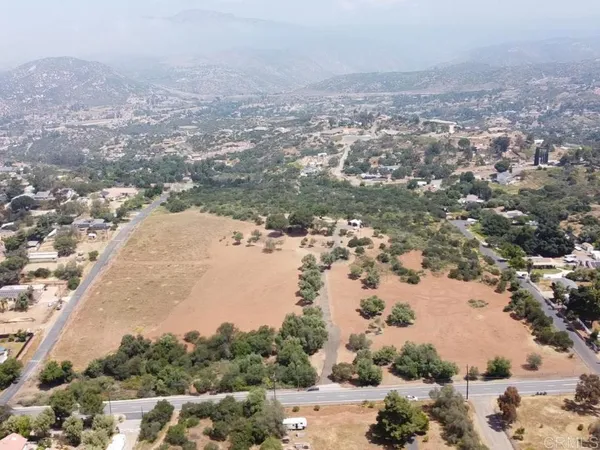 an aerial view of lake and residential houses with outdoor space