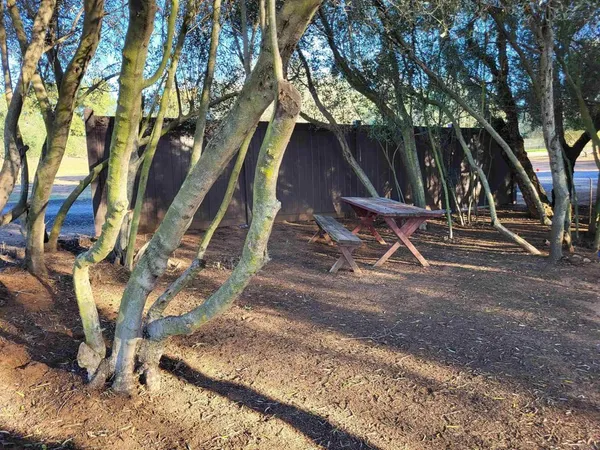 a backyard of a house with table and chairs