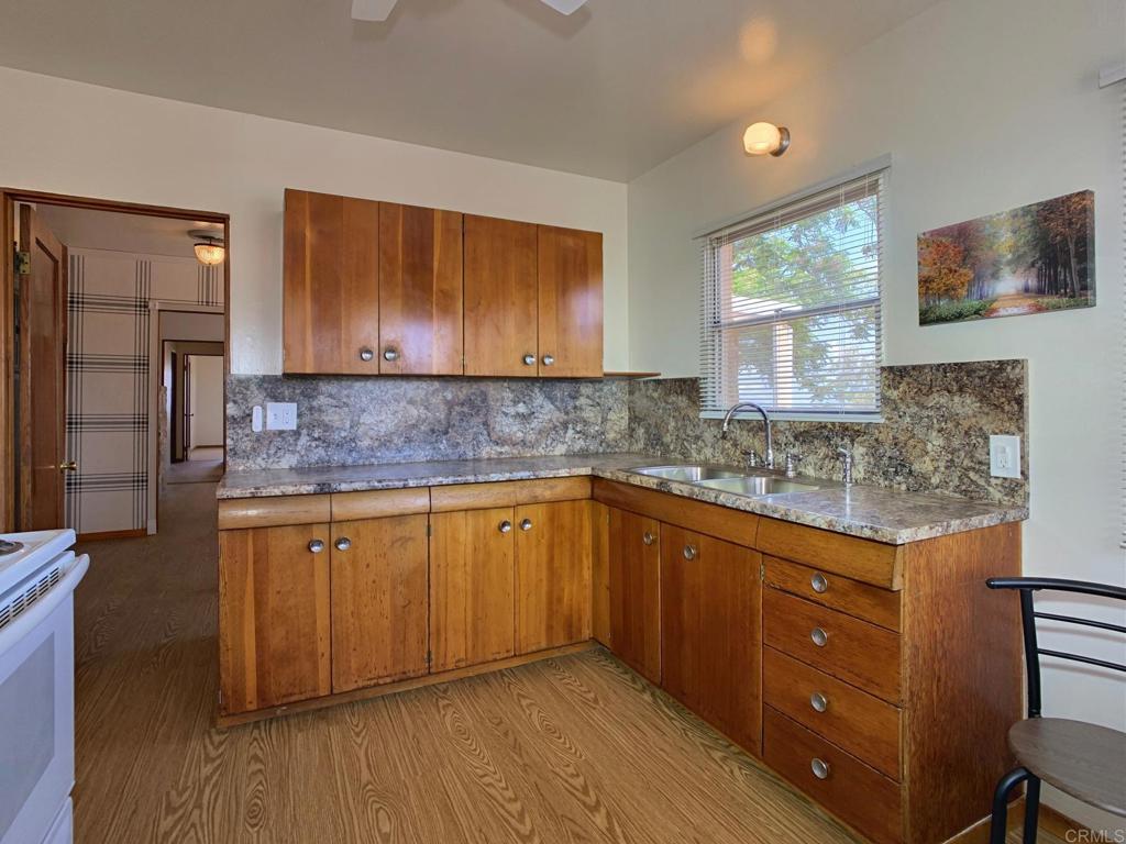 616 Alpine Heights Road Alpine, CA 91901 - Photo 10 of 50 a kitchen with stainless steel appliances granite countertop wooden cabinets a sink and dishwasher a refrigerator with wooden floor