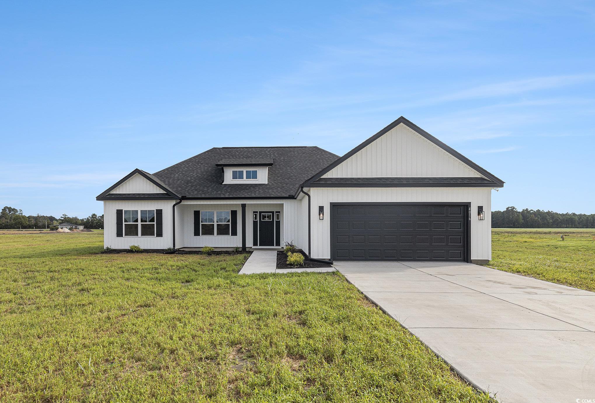 4016 Macks Road Aynor, SC 29511 - Photo 1 of 32 Modern farmhouse style home featuring roof with shingles, a front yard, concrete driveway, and a garage