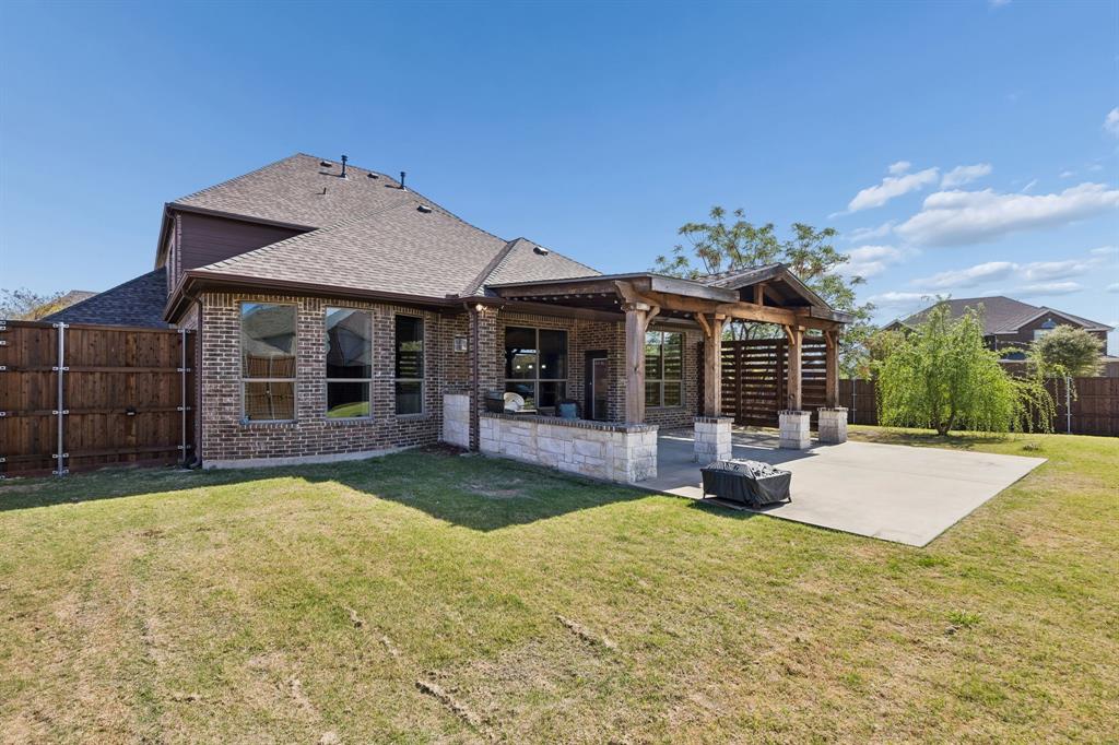1341 Canary Lane Forney, TX 75126 - Photo 3 of 34 Expanded back patio with pergola.