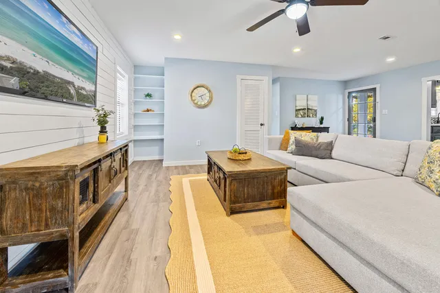 a spacious bedroom with a bed a couch and a chandelier