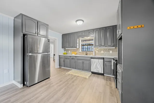 a kitchen with stainless steel appliances a refrigerator and a stove top oven