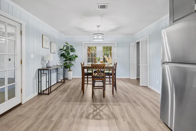 a view of a dining room with furniture window and wooden floor