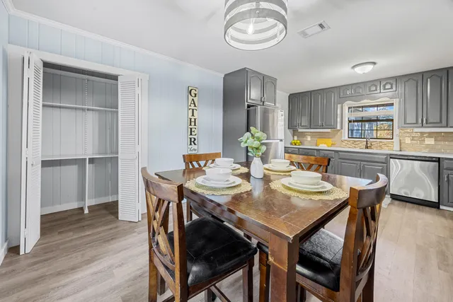 a view of a dining room with furniture window and wooden floor