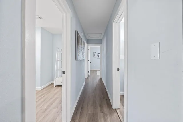 a view of a hallway with wooden floor