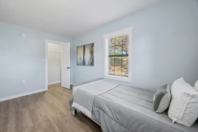 a bedroom with a bed and a window