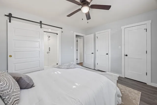 a bedroom with a bed and a chandelier