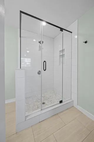a bathroom that has a glass shower door