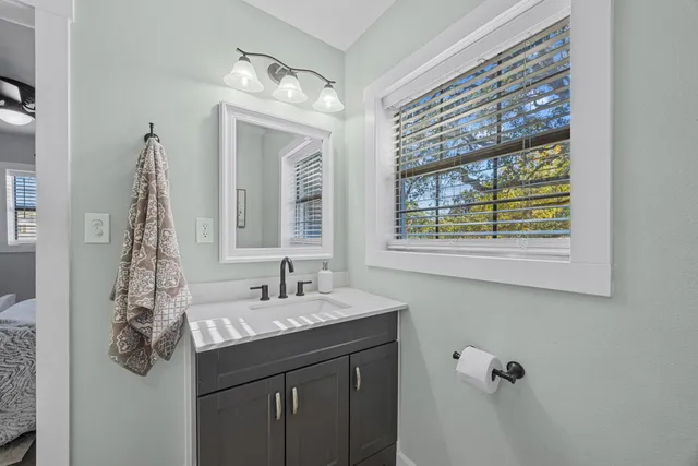 a bathroom with a sink vanity and mirror