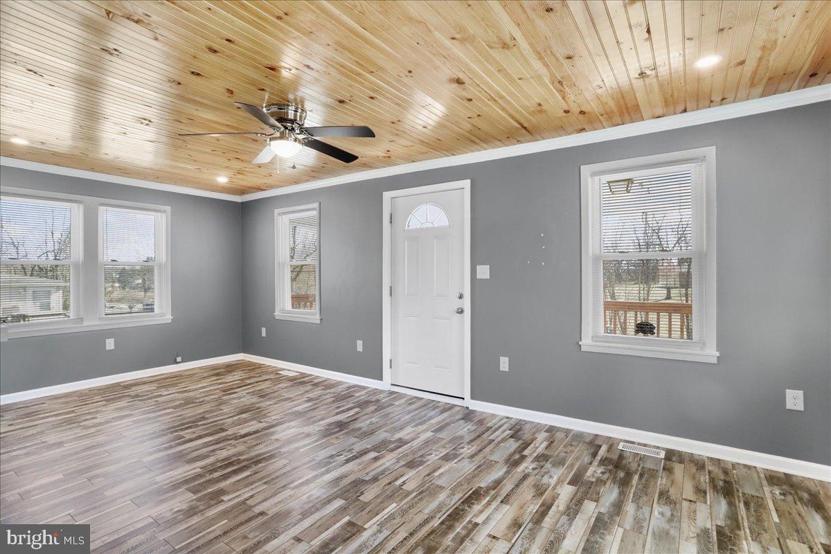 17 Turkey Hl Road Augusta, WV 26704 - Photo 14 of 33 a view of empty room with wooden floor and fan