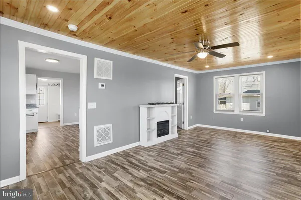 a view of an empty room with a fireplace and a window