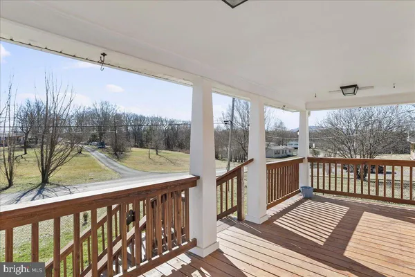 a view of a balcony with wooden floor