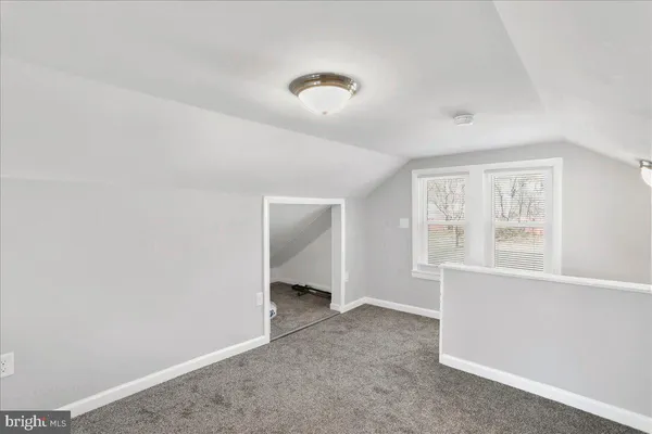 an empty room with a window and closet