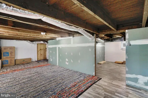 a view of a room with wooden floor