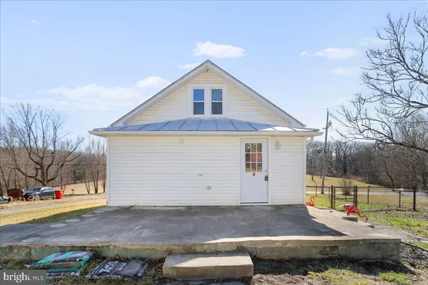 a backyard of a house with yard and outdoor seating