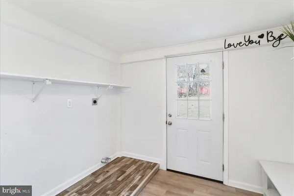 a view of a room with wooden floor