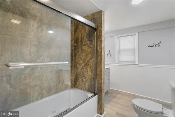 a bathroom with a shower and a toilet