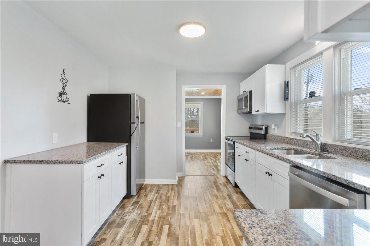 17 Turkey Hl Road Augusta, WV 26704 - Photo 10 of 33 a kitchen with granite countertop a sink stove and refrigerator