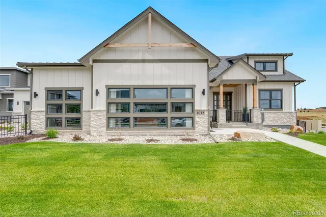 a front view of a house with a yard and porch