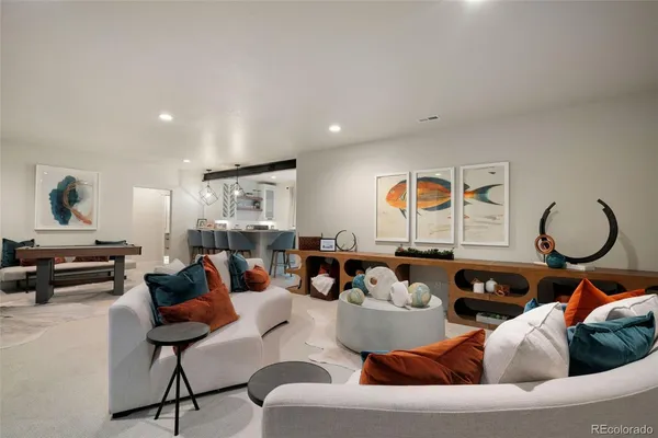 a living room with furniture a rug and a large window