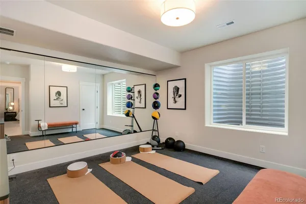 a room with gym equipment and a window