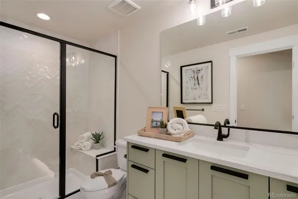 a bathroom with a sink a toilet and mirror