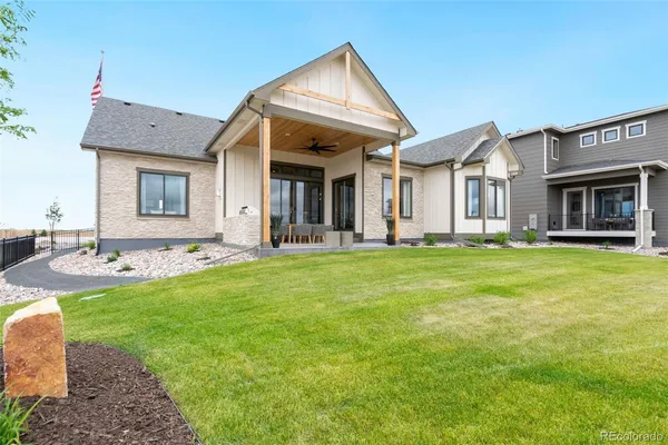a front view of house with yard and outdoor seating
