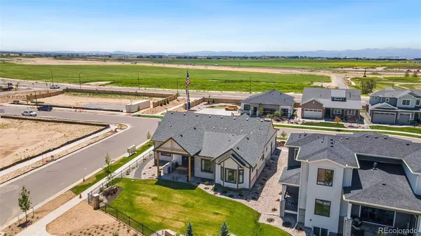 an aerial view of residential houses with outdoor space and ocean view