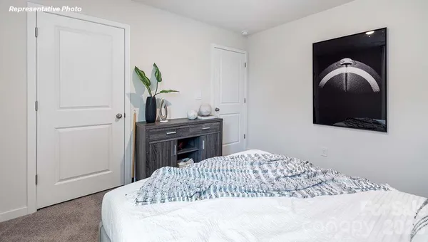 a bedroom with a bed and a television