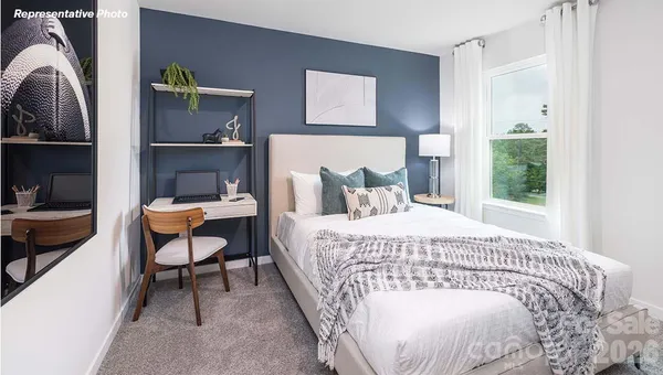 a bedroom with a bed a table and chair