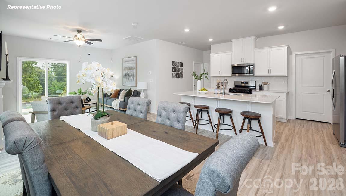 1431 Mammoth Road Hickory, NC 28602 - Photo 8 of 30 a living room with stainless steel appliances kitchen island granite countertop furniture a rug kitchen view and a large window