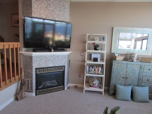 59 Oceanside Drive, Unit 59 Hull, MA 02045 - Photo 14 of 29 a living room with furniture a flat screen tv and a fireplace