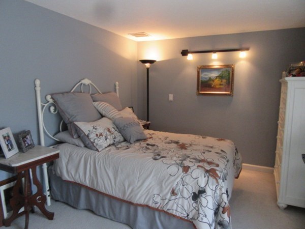 59 Oceanside Drive, Unit 59 Hull, MA 02045 - Photo 21 of 29 a bedroom with a bed and painting on the wall