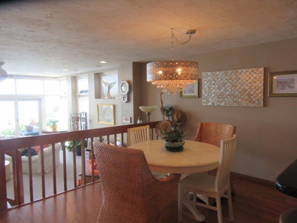 59 Oceanside Drive, Unit 59 Hull, MA 02045 - Photo 9 of 29 a view of a dining room with furniture window and wooden floor