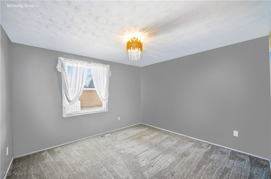 245 North Road Niles, OH 44446 - Photo 28 of 45 Virtual Stagged /painted room.Carpeted empty room with a textured ceiling and baseboards
