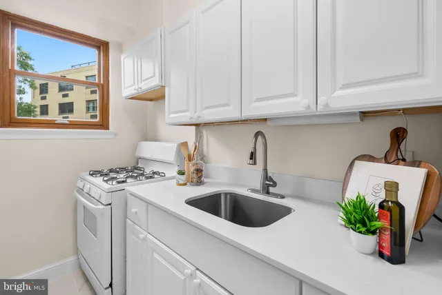 a kitchen with a sink stove and cabinets