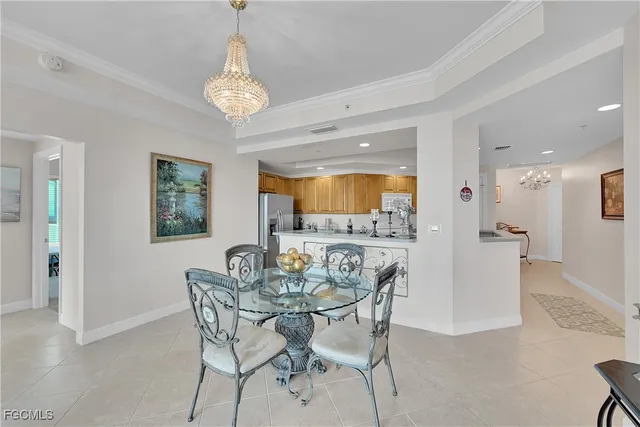 a view of a dining room with furniture and a chandelier