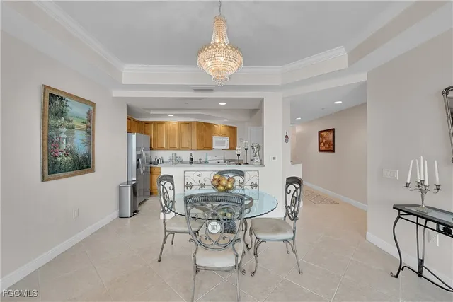 a view of a dining room with furniture and a chandelier