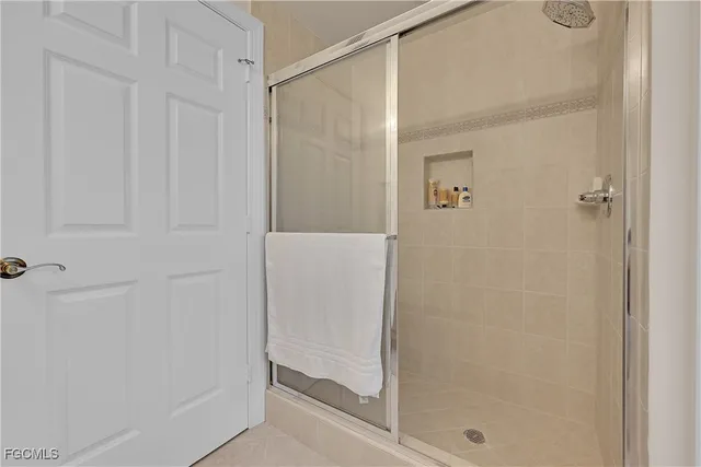a bathroom with a glass shower door